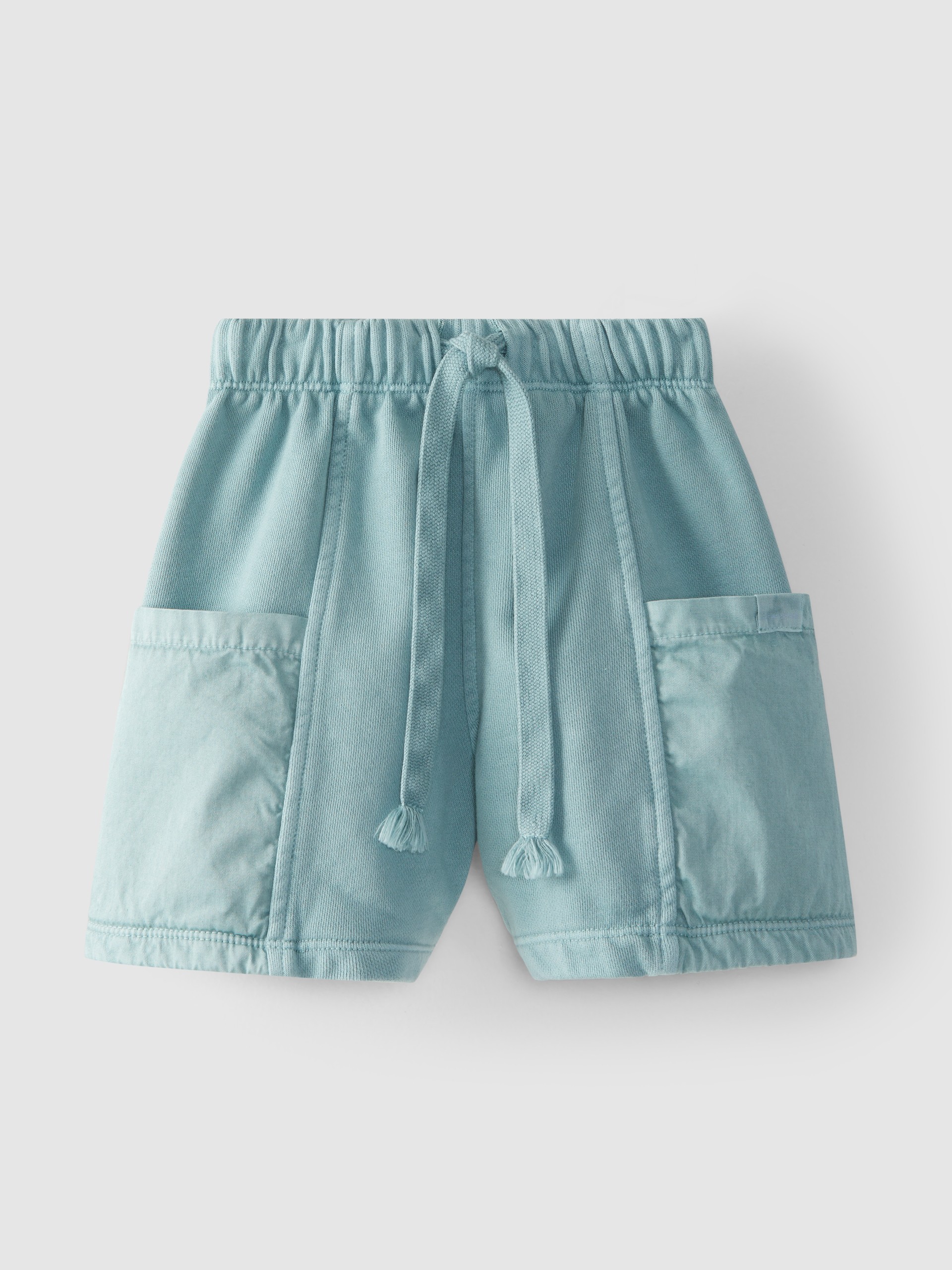 Pantalones cortos en felpa con bolsillos de tela