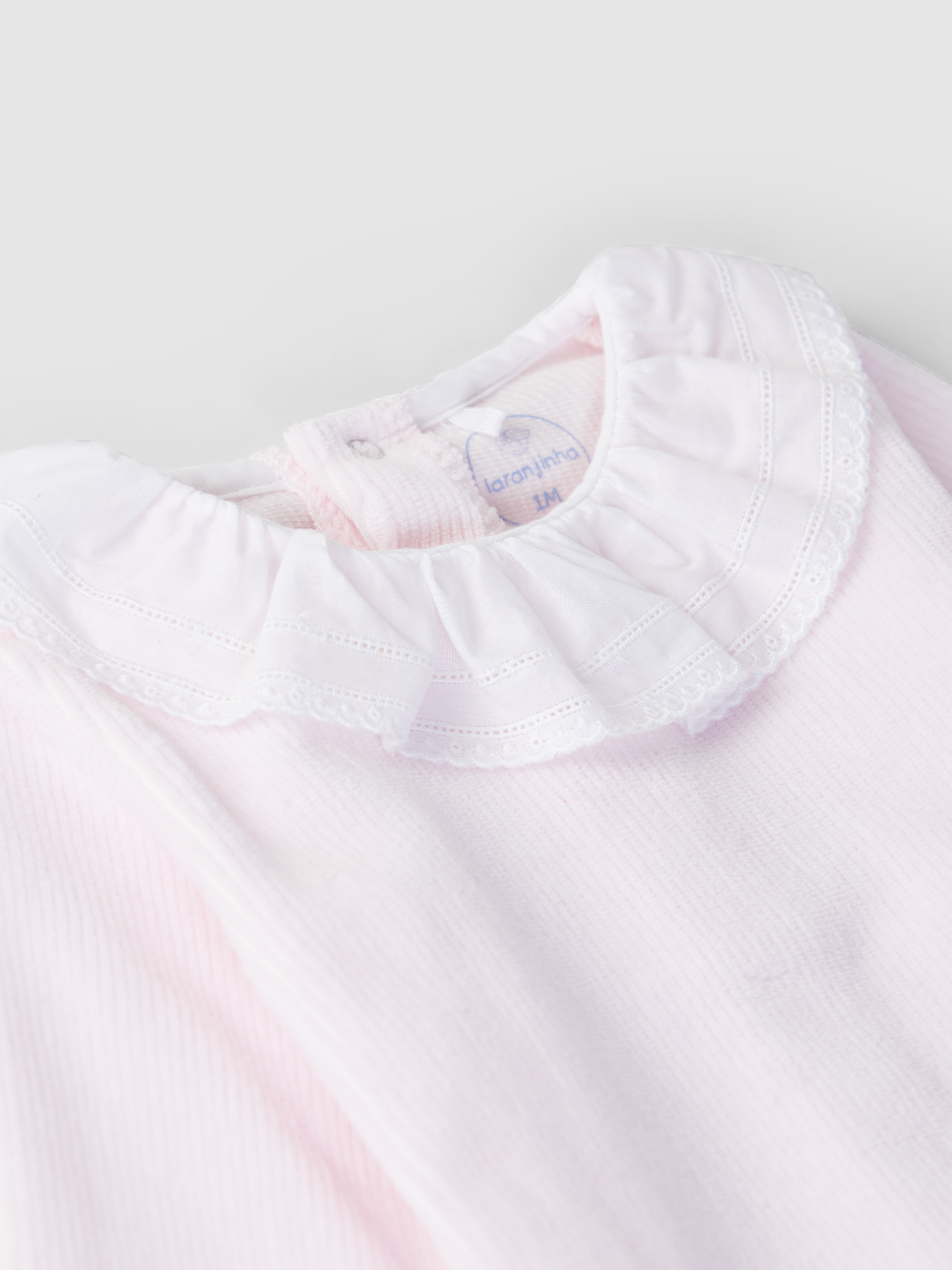 Ribbed velvet babygrow with ruffled collar