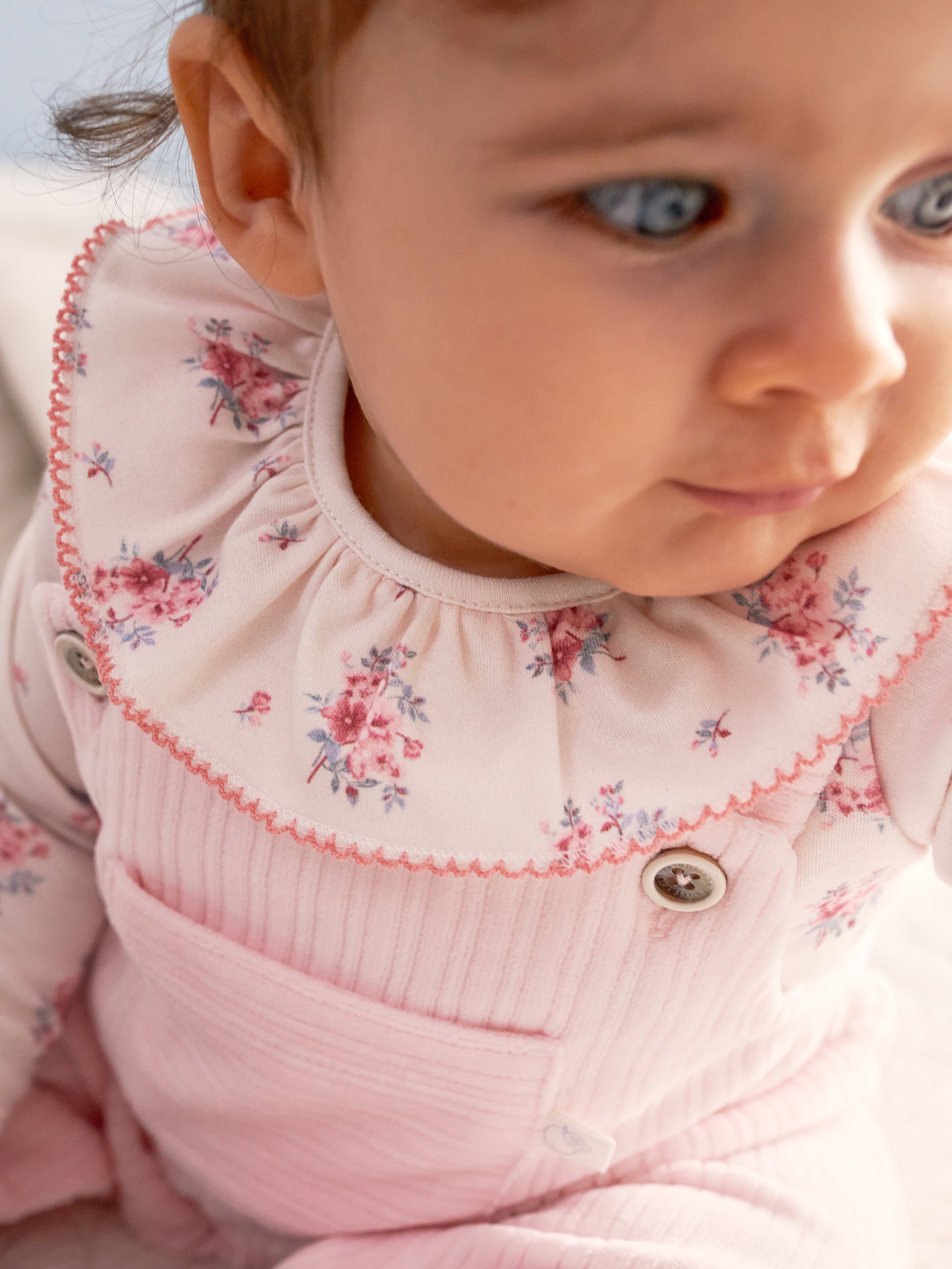 Floral print bodysuit with ruffled detail