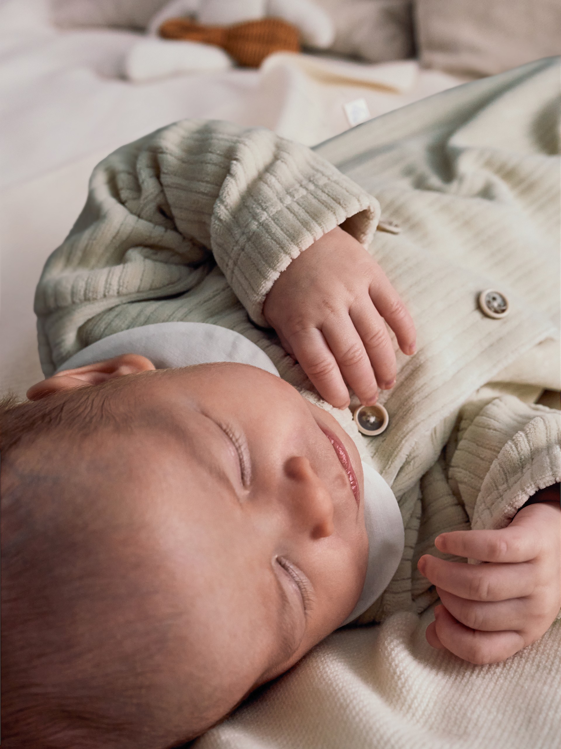 Ribbed velvet babygrow with decorative buttons
