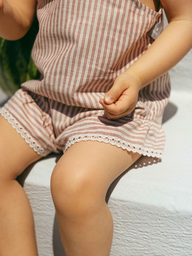 Overalls in striped fabric and English embroidery detail Overalls in striped fabric and English embroidery detail