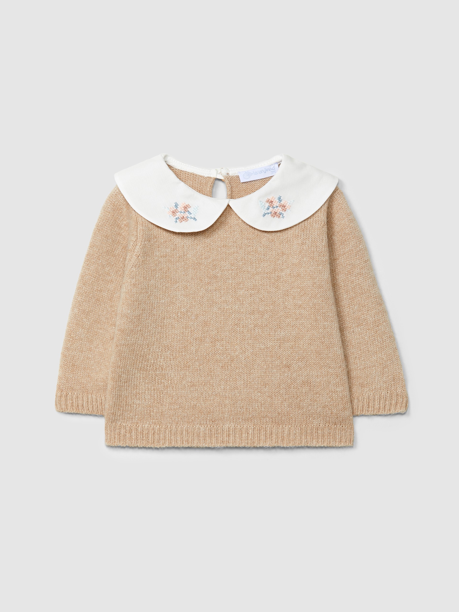 Knitted sweater with embroidered detail on the collar