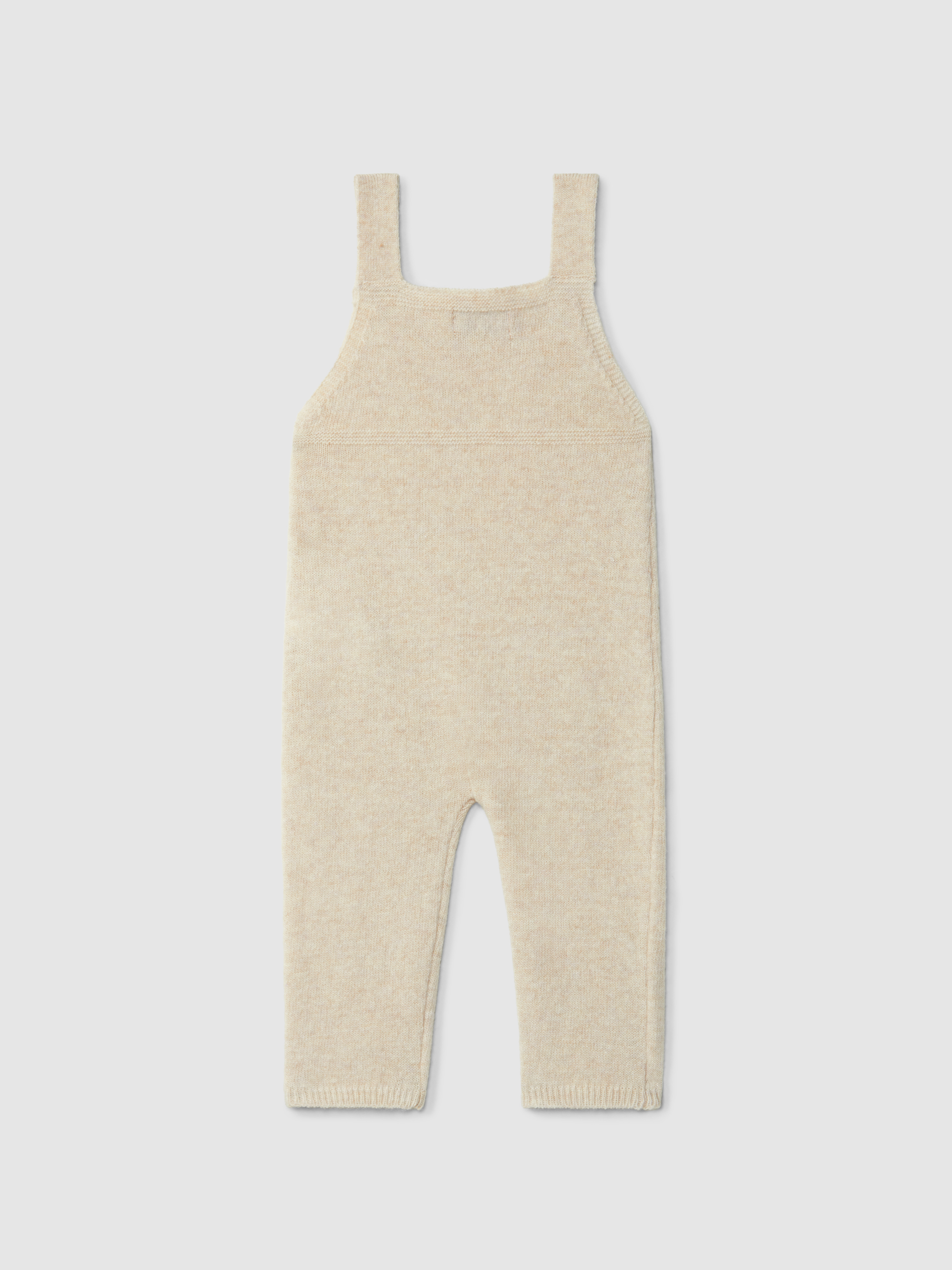 Dungarees knitted in wool with cable-knit detail
