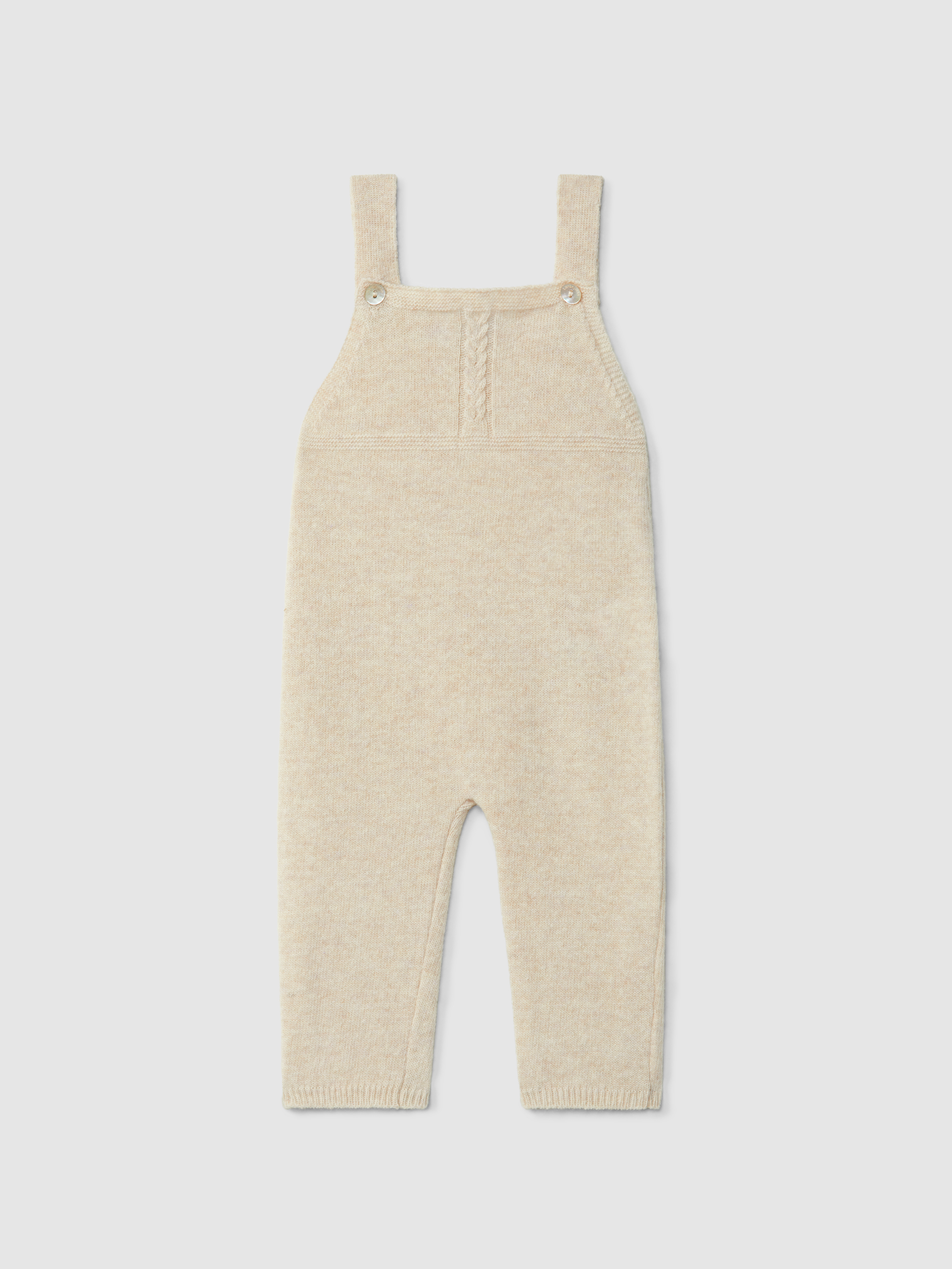 Dungarees knitted in wool with cable-knit detail